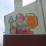 A cheerful cartoon-style bricklayer, holding a pint. Fine beer sold here.