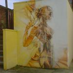 Graffiti art - an abstract/nude woman, in orange and sienna.