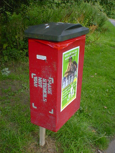 Make Stencils Not War, stencilled on the side of a dog-fouling bin