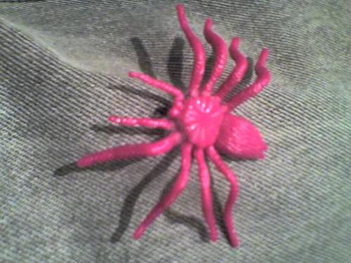 A bright pink plastic spider toy