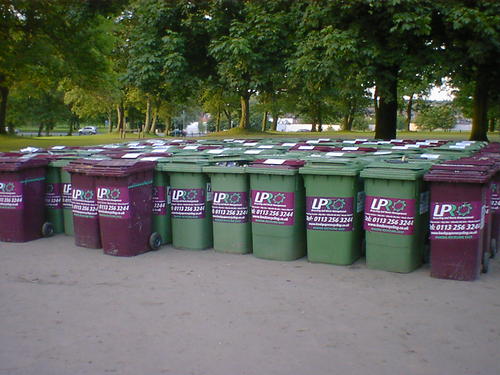 A hundred wheelie bins arranged in rows.