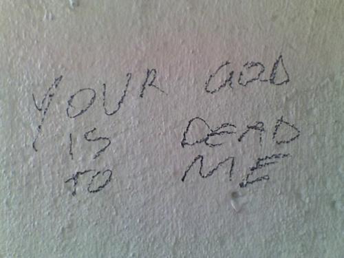 Graffiti reads: Your God Is Dead To Me