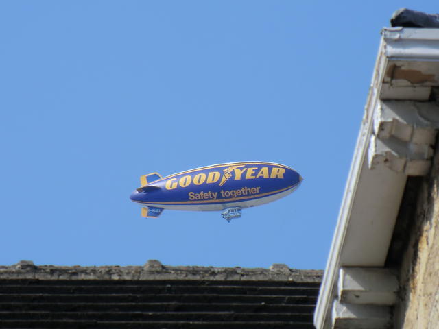 Look! The Goodyear Blimp! Photo of a Goodyear blimp above rooftop