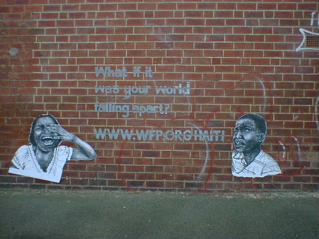 two wheatpaste posters of crying children, on a brick wall