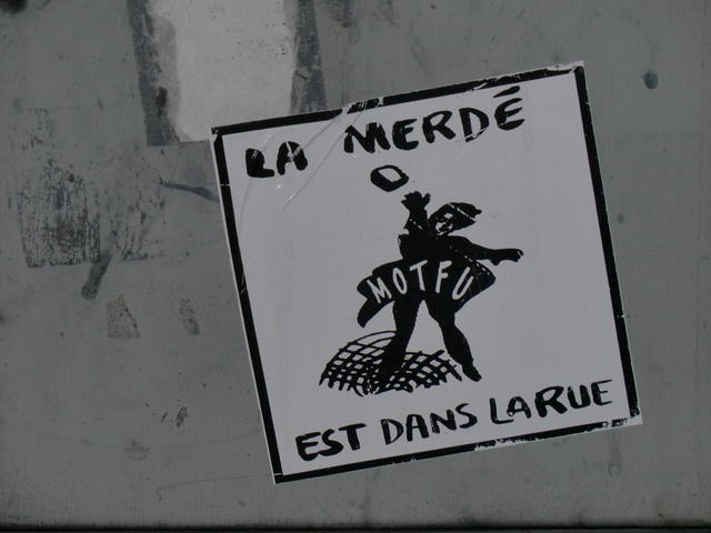 Sticker depicting anarchist reads: La Merde et dans la Rue