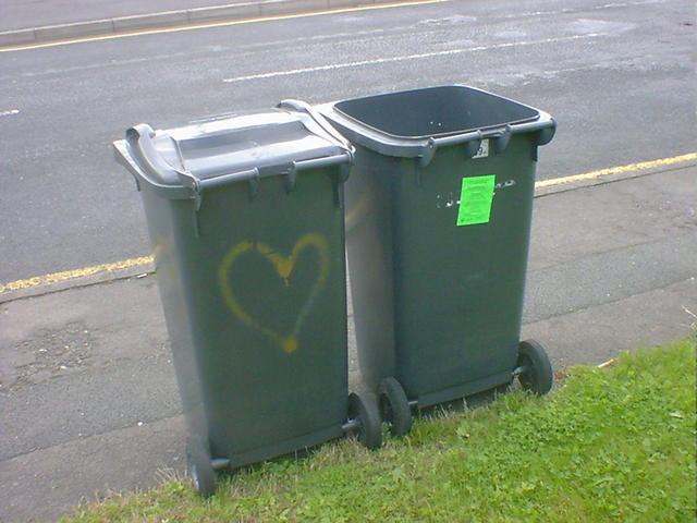 It Must be Love Two wheelie bins standing close together. One has a heart spray-painted on it.