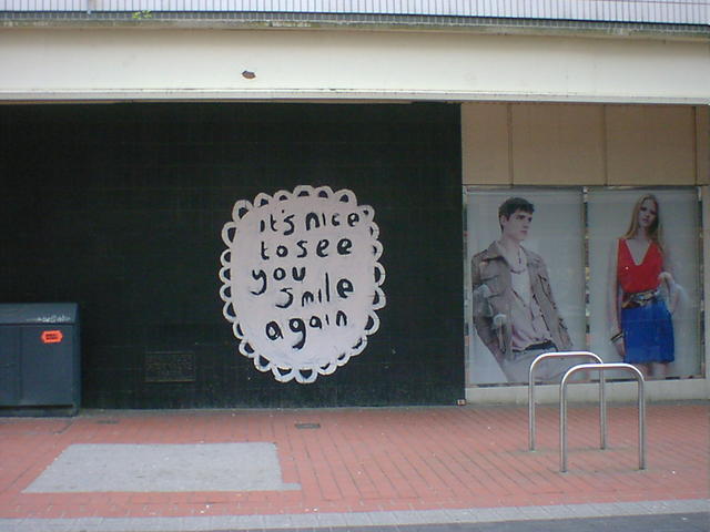 Graffiti reads: It's nice to see you smile again.