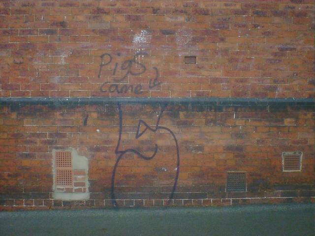 Pigs Came An aborted piece of graffiti, barely started. A note explains pigs came.