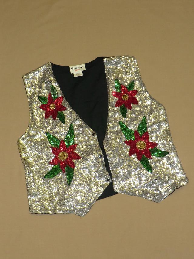 A sequined waistcoat, silver with red, green and gold flowers.