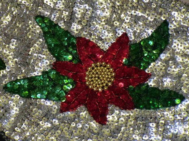 Flower design using red and green sequins, plus gold beads.