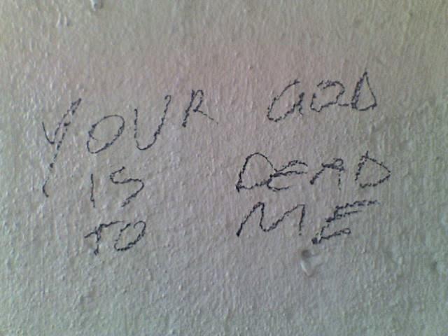 Graffiti reads: Your God Is Dead To Me