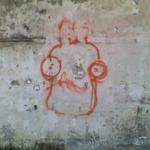 graffiti on decaying wall, a googley-eyed face resembling Admiral Akbar