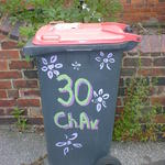 A wheelie bin with painted flowers and the word Chav, for Chestnut Avenue
