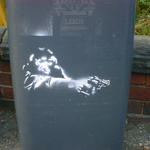 Stencil art on a wheelie bin. A monkey aiming a revolver, cop-show style