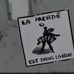 Sticker depicting anarchist reads: La Merde et dans la Rue