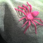 A bright pink plastic spider toy