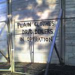 Graffiti reads: plain clothes drug dealers in operation