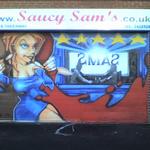 Graffiti-style artwork on the steel roll-shutters of a sandwich shop. 