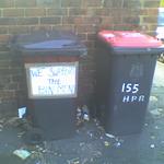 a sign affixed to a wheelie bin declares: we support the bin men