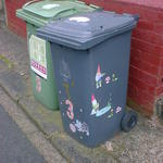 Gnome stickers decorating a wheelie bin