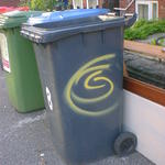 Yellow Spiral s[ray-paintes on a Wheelie Bin